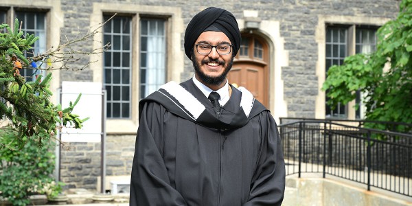 Abhay Sachal stands in front of the Birge Carnegie builing on the Victoria College campus.