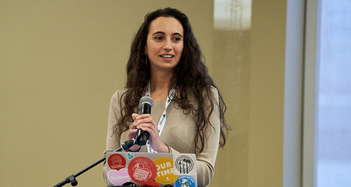 Aliénor Rougeot speaking at a podium.