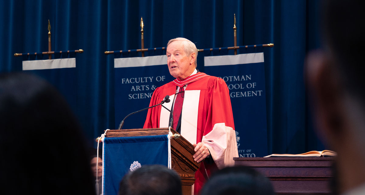 David Wilson stands at a podium in Convocation Hall.