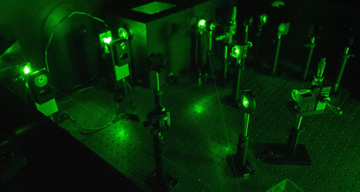 neon green lasers used to reflect light to create a hologram.
